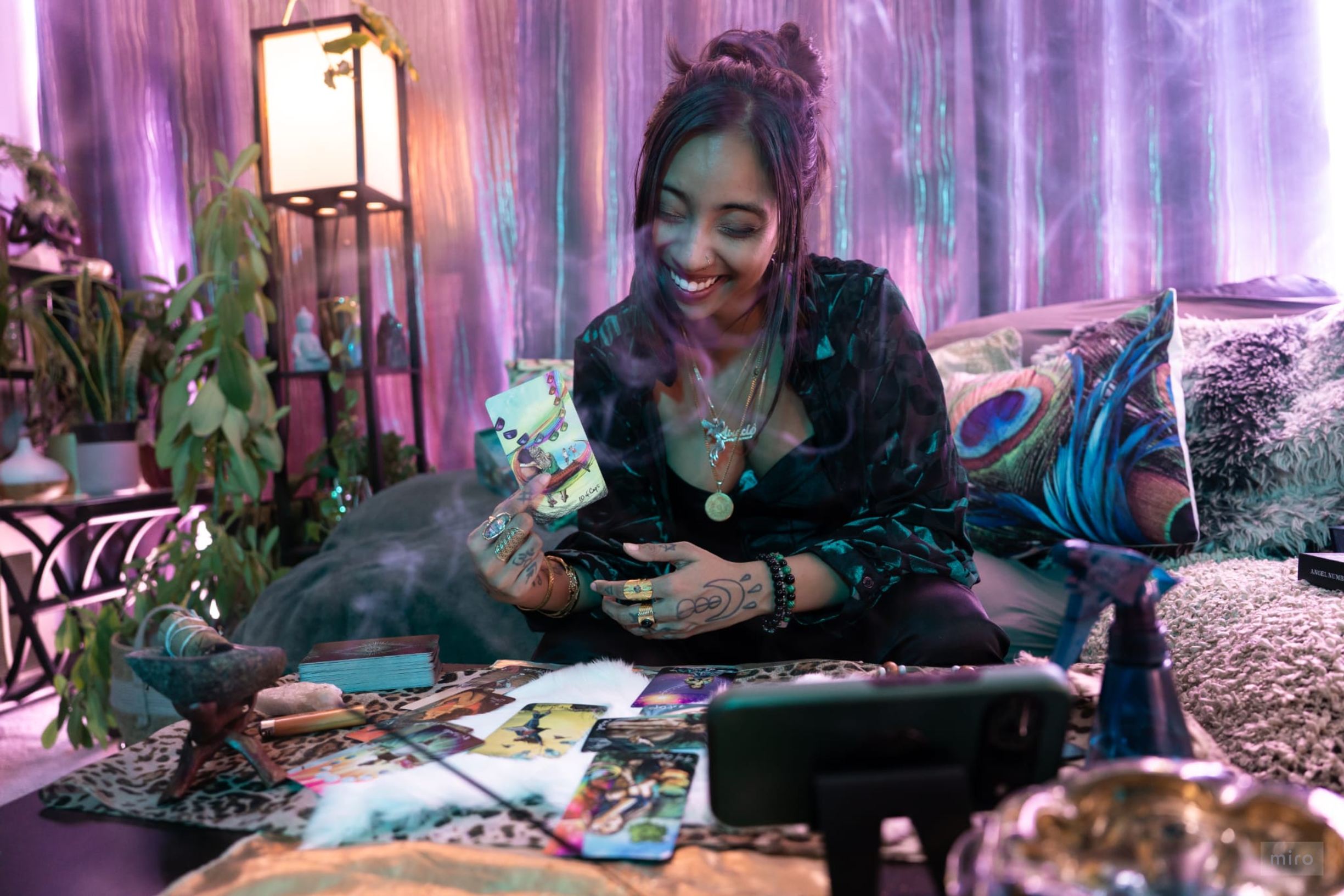 Mystical tarot reading session with cards spread on a table surrounded by candles and sacred objects